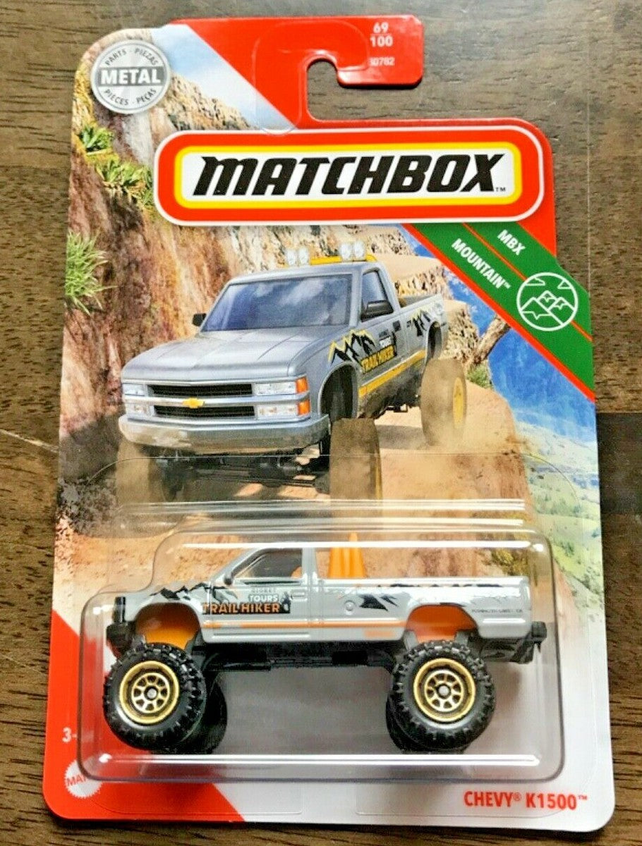 Matchbox Chevy K1500 (MBX Mountain) – Silver & Orange Trailhiker Lifted Pickup Truck (1:64 Scale)